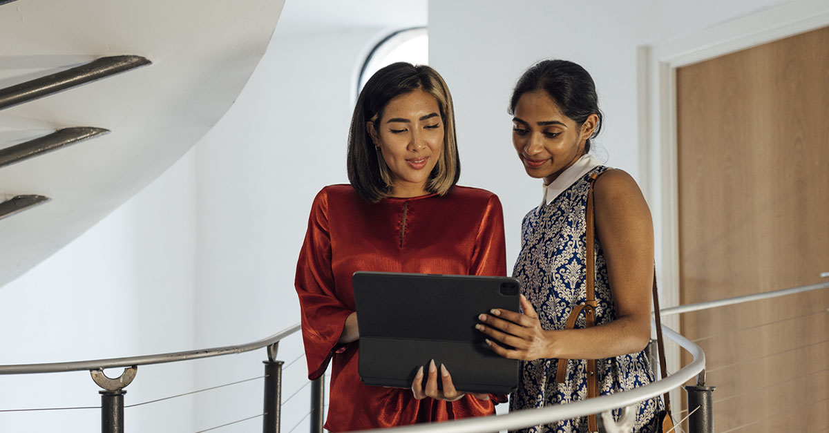 Two women discussing a document in an office