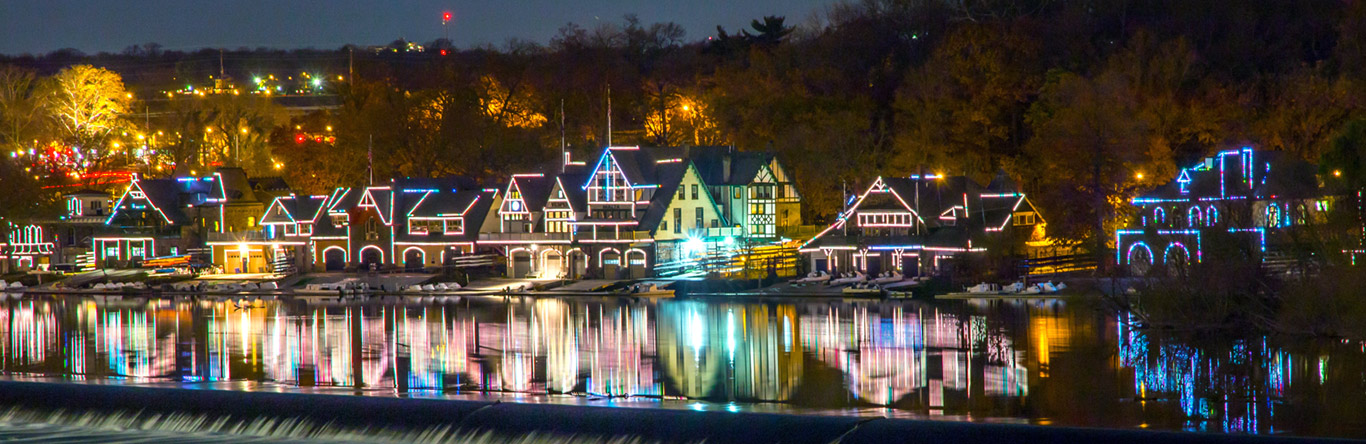 homes with colorful lights along river